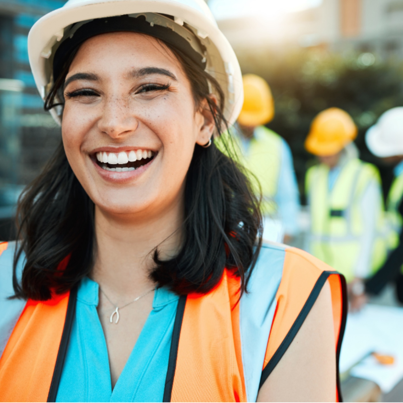 Smiling construction worker in a hard hat on site