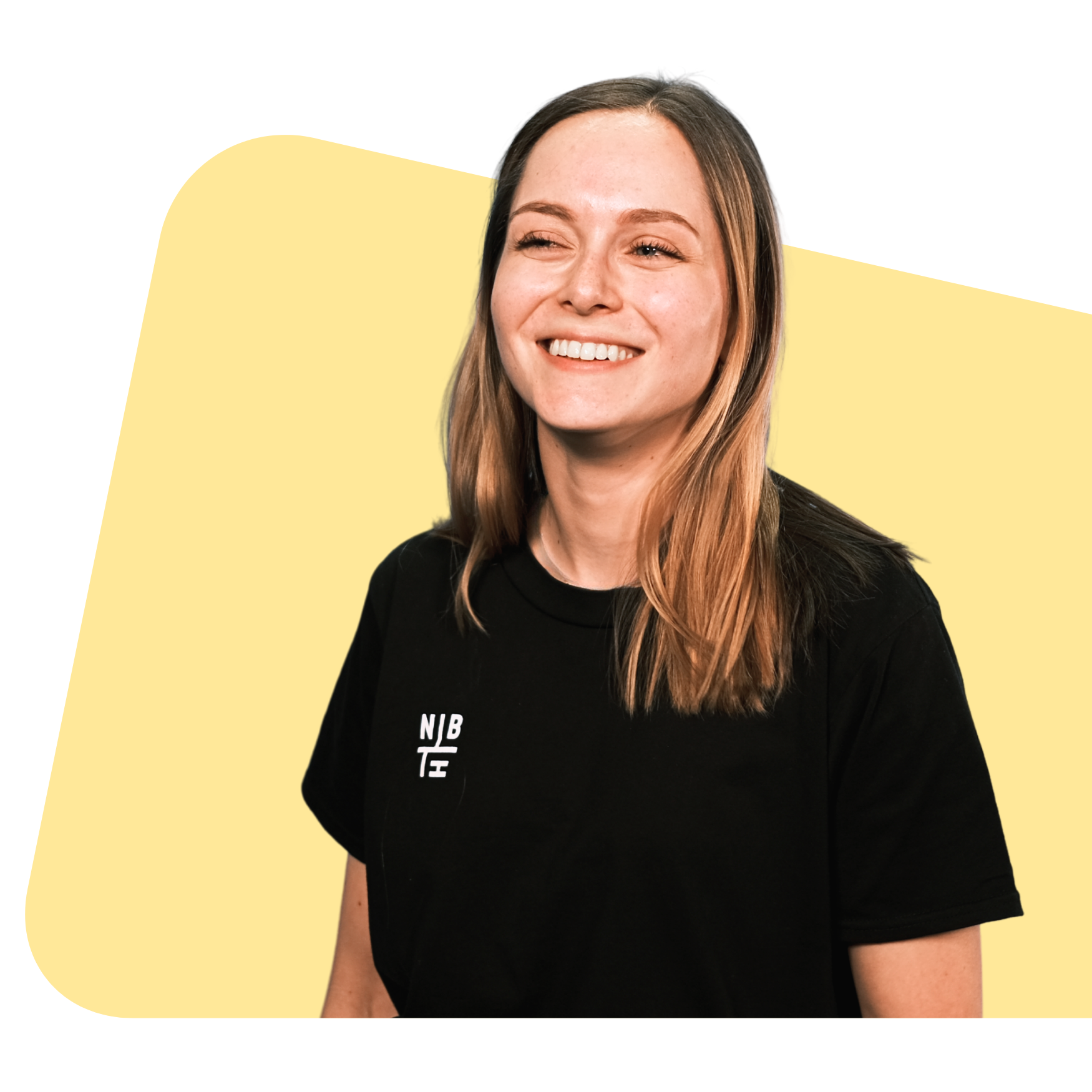 Smiling Neighbourhood team member in a black NBH tee, on a soft yellow shape