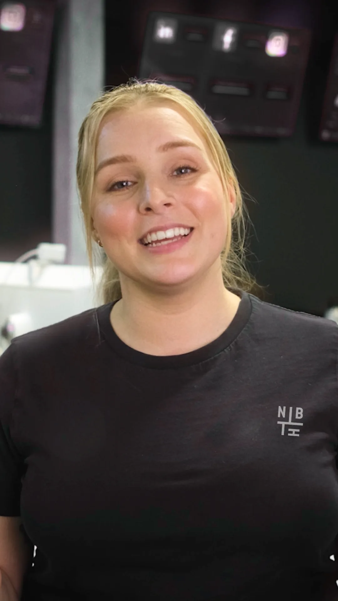 Neighbourhood team member in a black NBH tee at the office