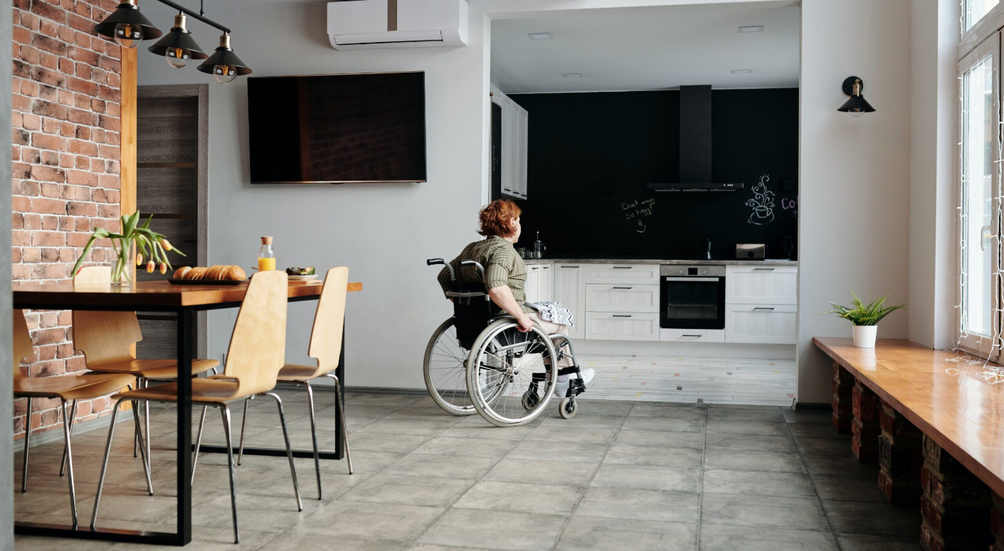 Apollo SDA — woman in wheelchair in a modern kitchen
